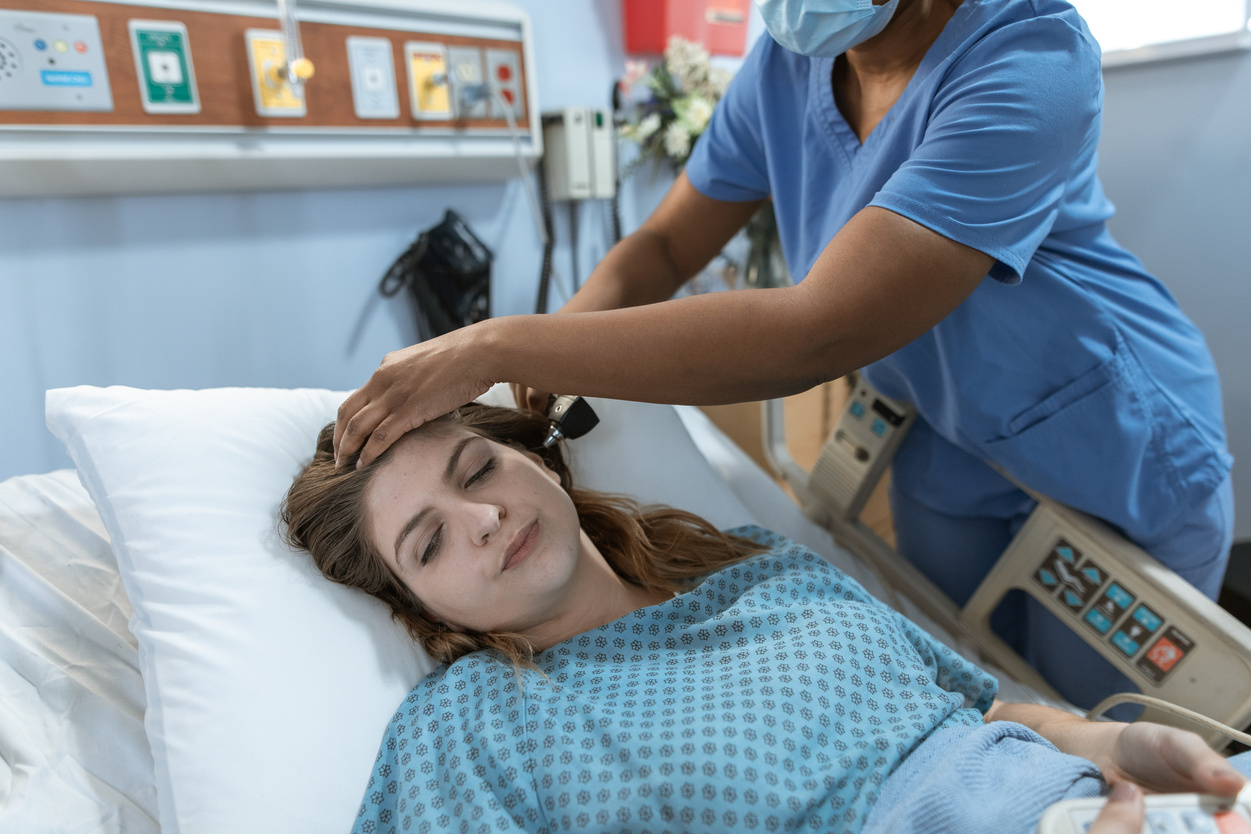 Crop black doctor checking up of patient